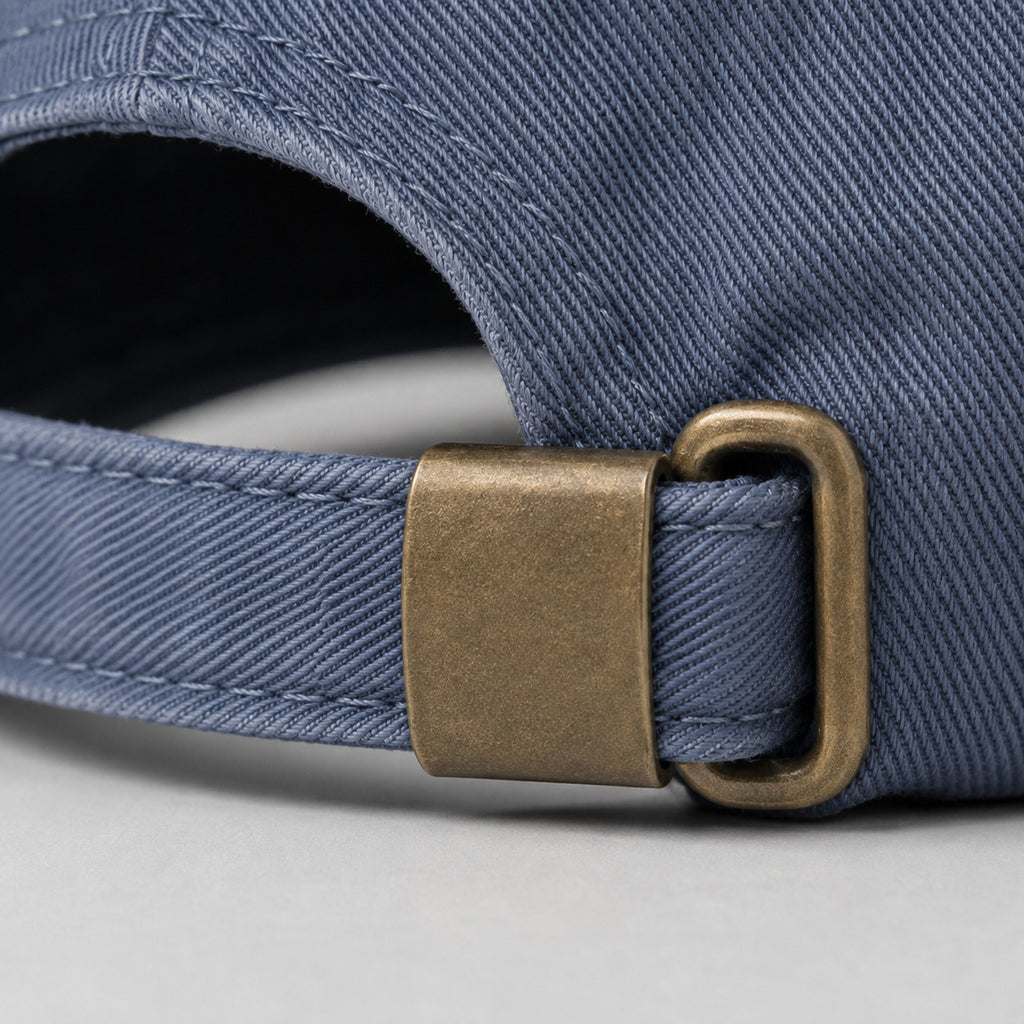 Close-up of the solid brass adjustable buckle on the back of the washed-blue Dachshund Cap