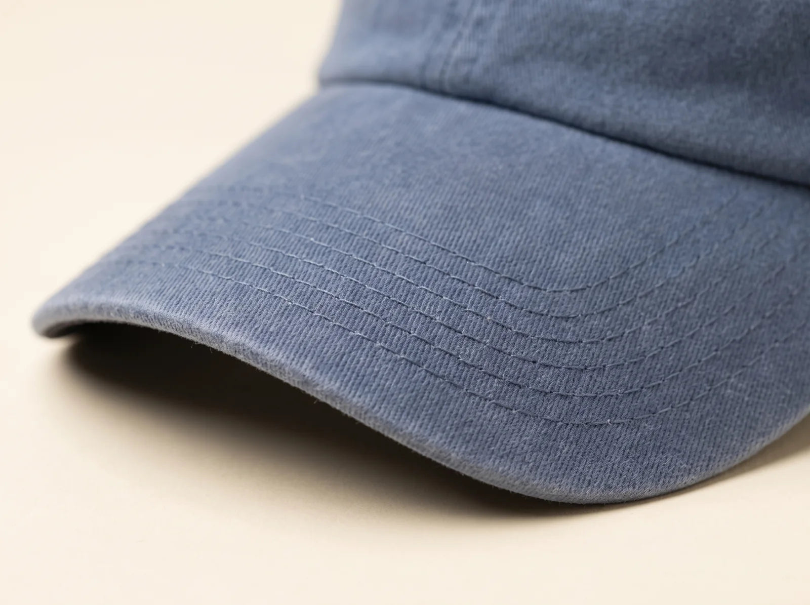 Close view of six evenly spaced stitch rows on the pre-curved blue visor
